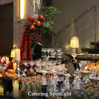 A magnificent grazing table set for an evening celebration. The display is a tapestry of colours and textures, with candles, fresh fruit, and an abundance of gourmet bites creating an atmosphere of luxurious indulgence.