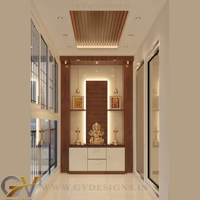 A balcony can be more than just a balcony; it can be a sanctuary. For this home, we designed a serene puja space in the balcony, creating a peaceful corner for reflection that benefits from natural light and air. The design incorporates custom cabinetry, elegant backlighting, and a wooden rafter ceiling detail.