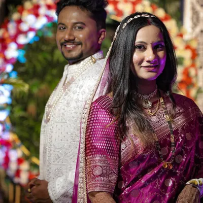 A royal reception look for a majestic bride. Her makeup is timeless and elegant, paired with a beautiful magenta saree to create an unforgettable evening look.