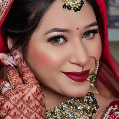 A close-up of my Barbie Doll bride. This shot highlights the intricate details of her makeup, from the glittery eyeshadow to the bold red lips, all complementing her traditional bridal jewelry.