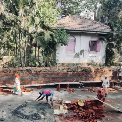 A team of masons at work laying bricks for a new foundation wall at one of our Alibaug sites. This foundational work is critical for ensuring the longevity of the structures we restore and build.