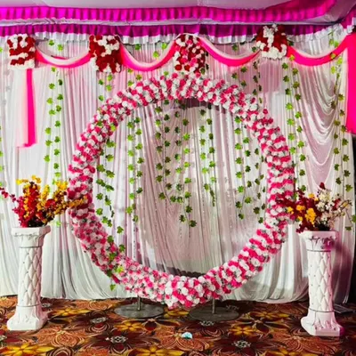 To show my range beyond balloons, here is a traditional circular arch I created for a Ganesha festival celebration. The entire ring is covered in pink and white flowers, with hanging green vines providing a beautiful, classic backdrop for any cultural or religious event.