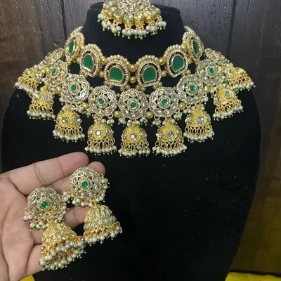 This gorgeous green stone choker with hanging jhumkis is a very popular rental piece for siders and bridesmaids. Here you can see the matching oversized jhumka earrings held up for a sense of scale.