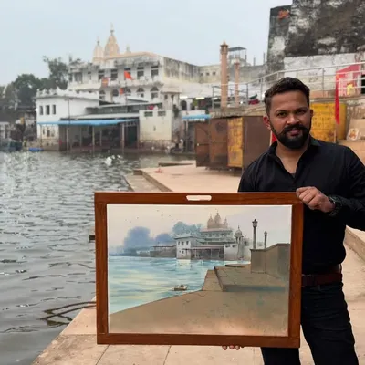 Holding my completed watercolour painting at the Pushkar ghat in Rajasthan. This was painted on location during a national artist camp.