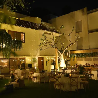 A wide shot of a stunning backyard transformation for a housewarming. We used elegant table settings, cozy lounge areas, and an abundance of fairy lights to create a truly magical garden party atmosphere.