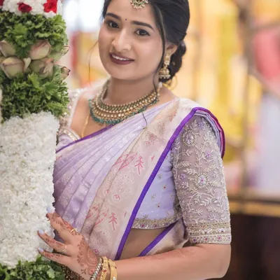 Bhavana celebrating her housewarming ceremony in a beautiful lavender Kanchivaram saree. I designed a matching blouse with intricate silver and lavender thread embroidery on the sleeves.