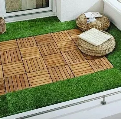 I love combining materials for a custom look. This balcony floor features a central 'rug' of wooden deck tiles surrounded by a border of soft artificial grass, offering the best of both worlds.
