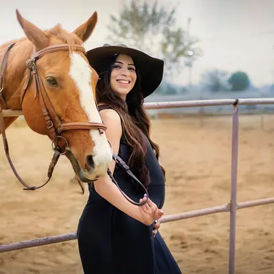 A beautiful and unique outdoor maternity portrait. The mom-to-be shares a sweet moment with a horse, perfectly capturing her love for animals during this special time.