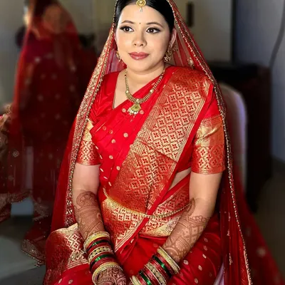 The making of a Maharashtrian bride. This look features the traditional 'Chandrakor' bindi, a neat bun for the 'mundavalya', and makeup that complements the rich texture of a Paithani saree.