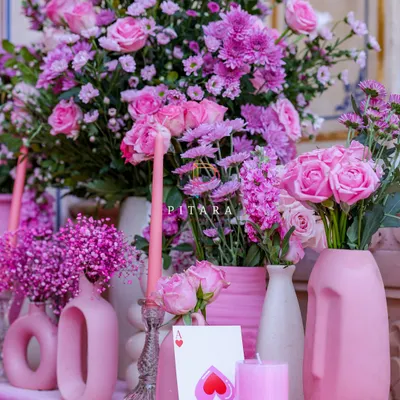 A console table that's a whole mood. I layered different shades of pink using modern, sculptural vases, taper candles, and an abundance of chrysanthemums and roses. It’s decor that’s confident and knows it looks good.