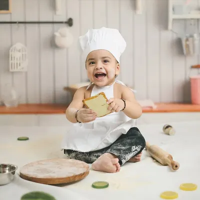 Cooking up some cuteness for a first birthday. This 'Little Chef' theme, complete with a chef's hat, apron, and a messy, flour-dusted kitchen set, is a recipe for adorable and playful photos.