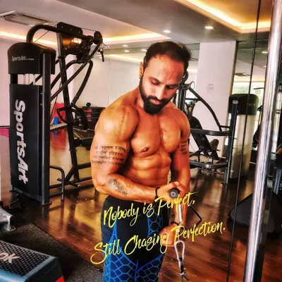 Focus and intensity during a bicep curl session at the gym. Professional equipment like this SportsArt machine allows for perfect muscle isolation, but the real work comes from your mind-muscle connection.