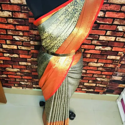This is the final draped look with fluffy pleats on a mannequin. A waist belt adds a modern touch to the traditional drape.