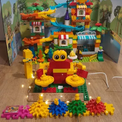 A colorful and interactive amusement park model built by our 'Tiny Tinkers' team using LEGO Discover kits, demonstrating their understanding of gears and simple machines.