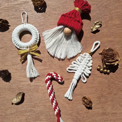 Get your jingle on with these handmade macrame ornaments. This set includes a Santa gnome, a candy cane, a wreath, and a tree, perfect for adding a boho touch to your Christmas tree.