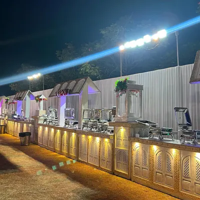 This is a look at one of my full-scale outdoor buffet setups. I use custom-built counters with elegant carvings and warm lighting to create a grand and inviting dining experience that complements the celebration, no matter the size of your guest list.