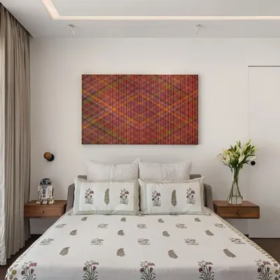 In the West Coast Residence, this bedroom is a serene space defined by clean lines and personal touches. The floating wooden nightstands and minimalist wall sconces keep the design uncluttered, while the client's own collectibles add a unique character.
