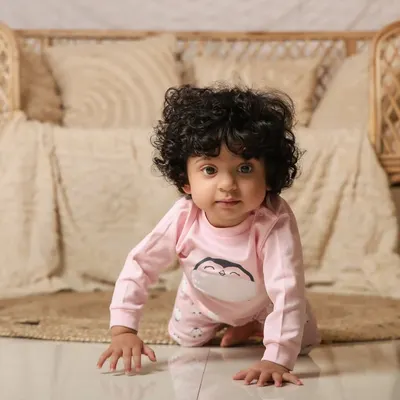 A sweet baby girl crawling in our cozy boho setup. The neutral tones and soft textures create a warm and inviting portrait.