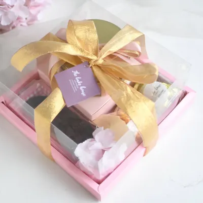 My grand Rakhi Hamper, packed with an assortment of goodies including brownies, cookies, and a Baklava tea cake, all tied up with a beautiful gold ribbon.