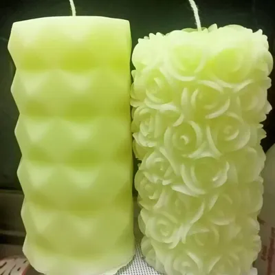 A side-by-side comparison of two of my most detailed designs: the diamond pillar and the intricate rose pillar candle, both in a soft lime green.