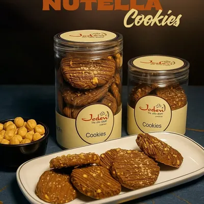 Our Nutella Cookies are a dream for any chocolate lover. We pack them with rich Nutella and crunchy nuts, ensuring every bite is a perfect balance of texture and taste. They are available in two jar sizes to suit your cravings.