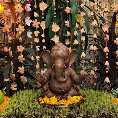 Our main Ganesha idol, beautifully decorated and ready for worship. We make our idols from natural clay, ensuring our celebrations are both auspicious and environmentally conscious.
