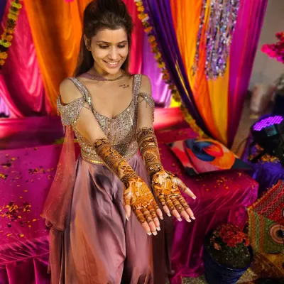 A beautiful bride smiling as she shows off her full bridal mehndi. It's an honor to be a part of such a special day.