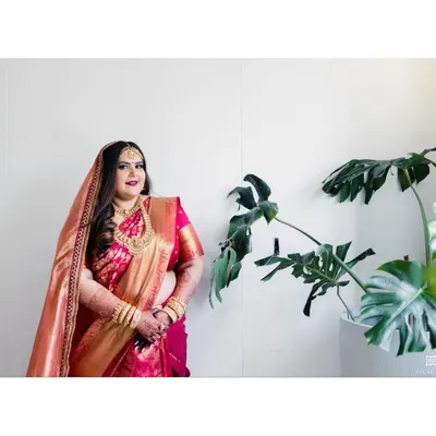 The bride, Ruchi, looking absolutely regal in her red and gold Kanjeevaram saree from Angadi. We paired it with traditional temple jewelry to create a classic and stunning Mallu bridal look.