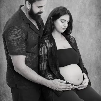 In this intimate black and white portrait, I captured the quiet promise between two parents-to-be, their hands joined over the life they created together.