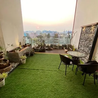 We converted this entire high-rise balcony into a complete garden retreat. The design incorporates artificial turf for a touch of green, a gabion feature wall, a stone-clad planter with a water feature, and a comfortable seating area to enjoy the sunset.