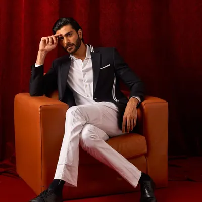 A classic black blazer with modern white striped details. Paired with a crisp white shirt and trousers, this is a powerful look for any formal setting.