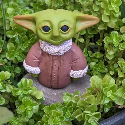 May the force be with you. This hand-sculpted Baby Yoda (Grogu) is made to order from polymer clay. He can be your everyday desk buddy or a perfect gift for the Star Wars fan in your life.