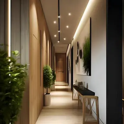 I designed this hallway with warm wood paneling and a combination of track and side lighting to create a long, inviting path through the home. The minimalist decor keeps the focus on the clean architecture.
