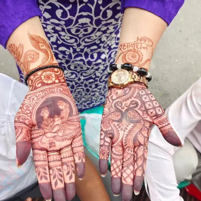 This design was created for Raksha Bandhan, featuring a Radha-Krishna portrait on one palm and "Happy Rakshabandhan" written on the other wrist. It's a beautiful way to celebrate the festival.