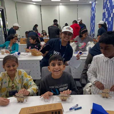 Look at those smiles! We had a jam-packed day at GE Aerospace for their summer family day event. The kids were completely absorbed in building their own little cardboard robots.