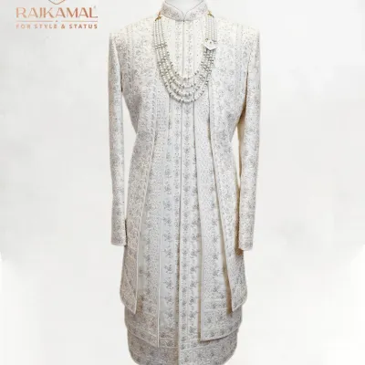 A complete view of my classic ivory sherwani, featuring subtle all-over embroidery and paired with a multi-layered pearl necklace. This is a look designed for the groom who desires pure, understated elegance.