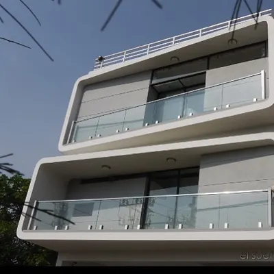 The striking facade of Saurabh’s Residence on Sarjapur Road is defined by its bold, rounded forms. The deep-set balconies with glass railings provide functional outdoor space while contributing to the building's unique sculptural quality.