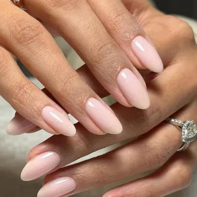 A classic and sophisticated look, these sheer pink almond nails are the perfect complement to a beautiful diamond ring.