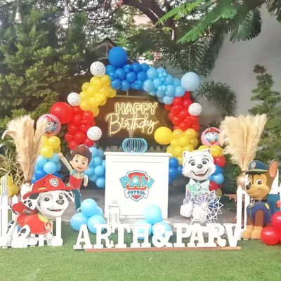 A fun-filled Paw Patrol birthday party theme. This setup includes a colorful balloon arch, character cutouts of the popular pups, and a personalized name display for the birthday kids.