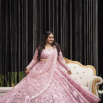 A pastel dream come true. This full-length shot shows how the soft pink makeup look harmonizes with the entire outfit, creating a cohesive and ethereal appearance for a daytime wedding.
