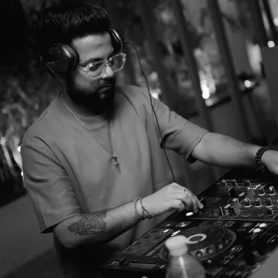 A black and white shot of me focused on the mixer during a live set. This is where I get lost in the music, blending tracks and reading the crowd.