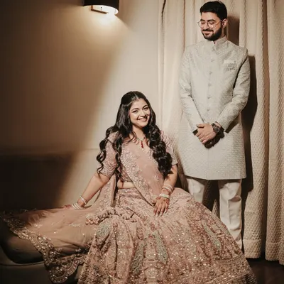 An elegant and formal portrait of the couple for their Roka ceremony. Her intricate lehenga and his classic sherwani are beautifully captured in this poised and graceful shot.