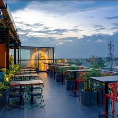 The rooftop terrace at Bramble Kitchen & Bar offers an expansive view, combining casual seating with lush planters to create an urban garden feel. This space was designed to be the main attraction, perfect for evening gatherings.