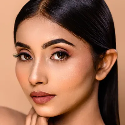 A flawless beauty shot. The focus is on the clean, minimal makeup and the model's perfect skin, achieved with professional retouching. This is ideal for a makeup artist's portfolio.
