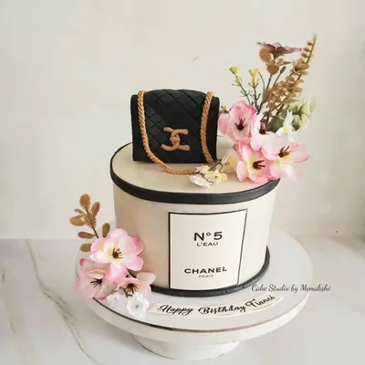 What's not to love about this Chanel themed cake? It features the iconic No. 5 logo and is topped with a handcrafted, quilted Chanel bag and beautiful flowers.