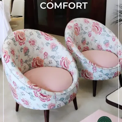 A pair of bespoke barrel chairs we upholstered in a vibrant floral fabric with soft pink seats. These chairs were designed to add a touch of bespoke comfort and personality to a client's sunroom.