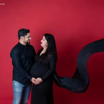 This is the same stunning maternity look as my featured shot, showcasing the beautiful black gown against a vibrant red background. I ensure we capture a variety of poses to give you a full and diverse gallery.