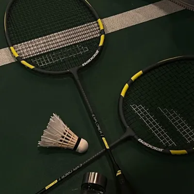 The tools of our favorite trade. A couple of rackets, a shuttle, and a water bottle to stay hydrated.