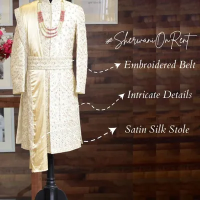 This is what a groom's outfit should look like. Our sherwani on rent features an embroidered belt, intricate detailing, and a satin silk stole for a complete, regal appearance.