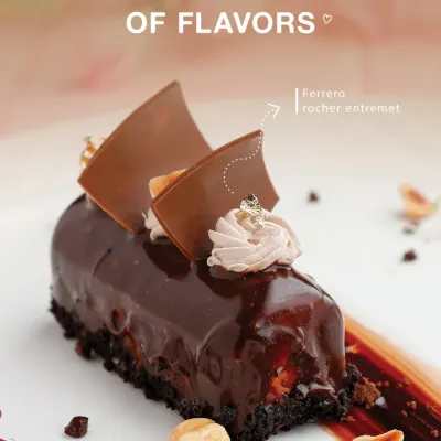 Indulgence redefined. Our Ferrero Rocher Entremet is a luxurious creation featuring layers of rich chocolate, crunchy hazelnut, and velvety mousse, finished with a glossy glaze and delicate gold leaf.